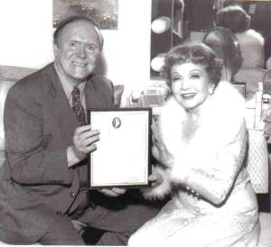 Larry Quirk gives award to Claudette Colbert